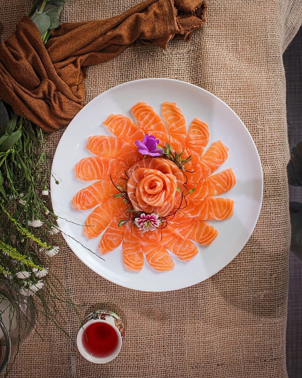 Mandala de sashimi de salmão com rosa ao centro, um dos pratos autorais da Otsu